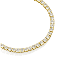 Gold bracelet with clear gemstones on a white background