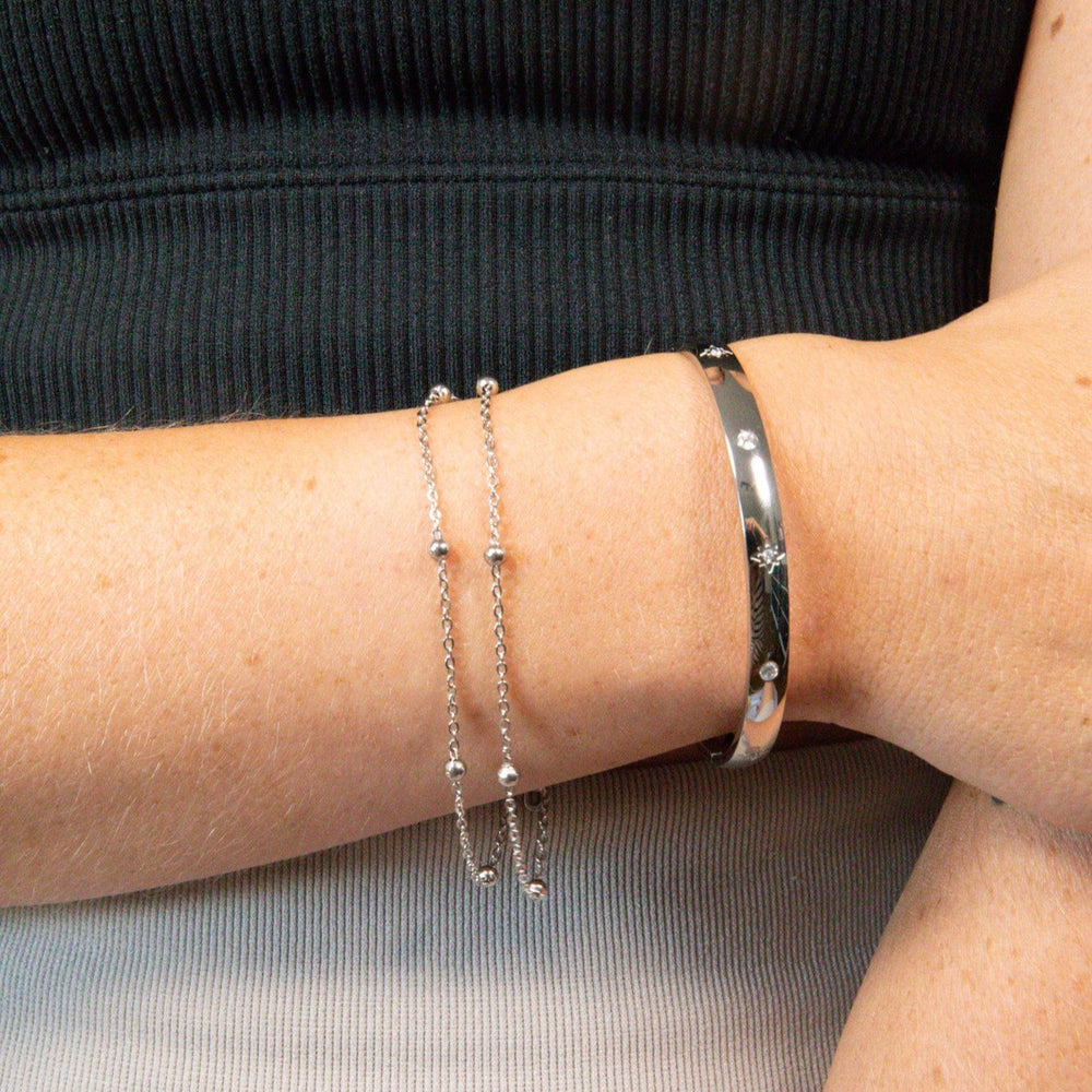 Star bangle with sparkle and hinged opening. Curved to fit the wrist. Made from recycled gold and silver.