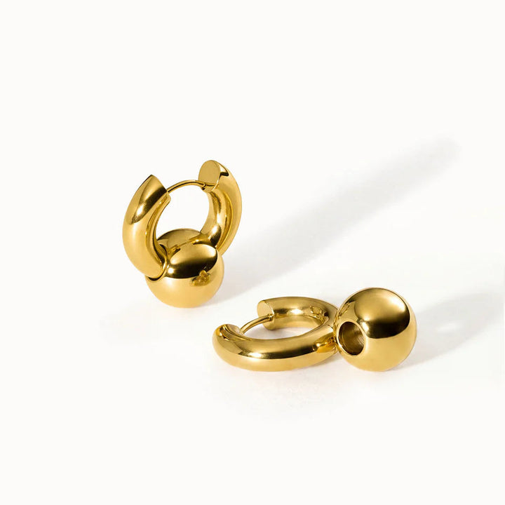 Gold hoop earrings on a white background