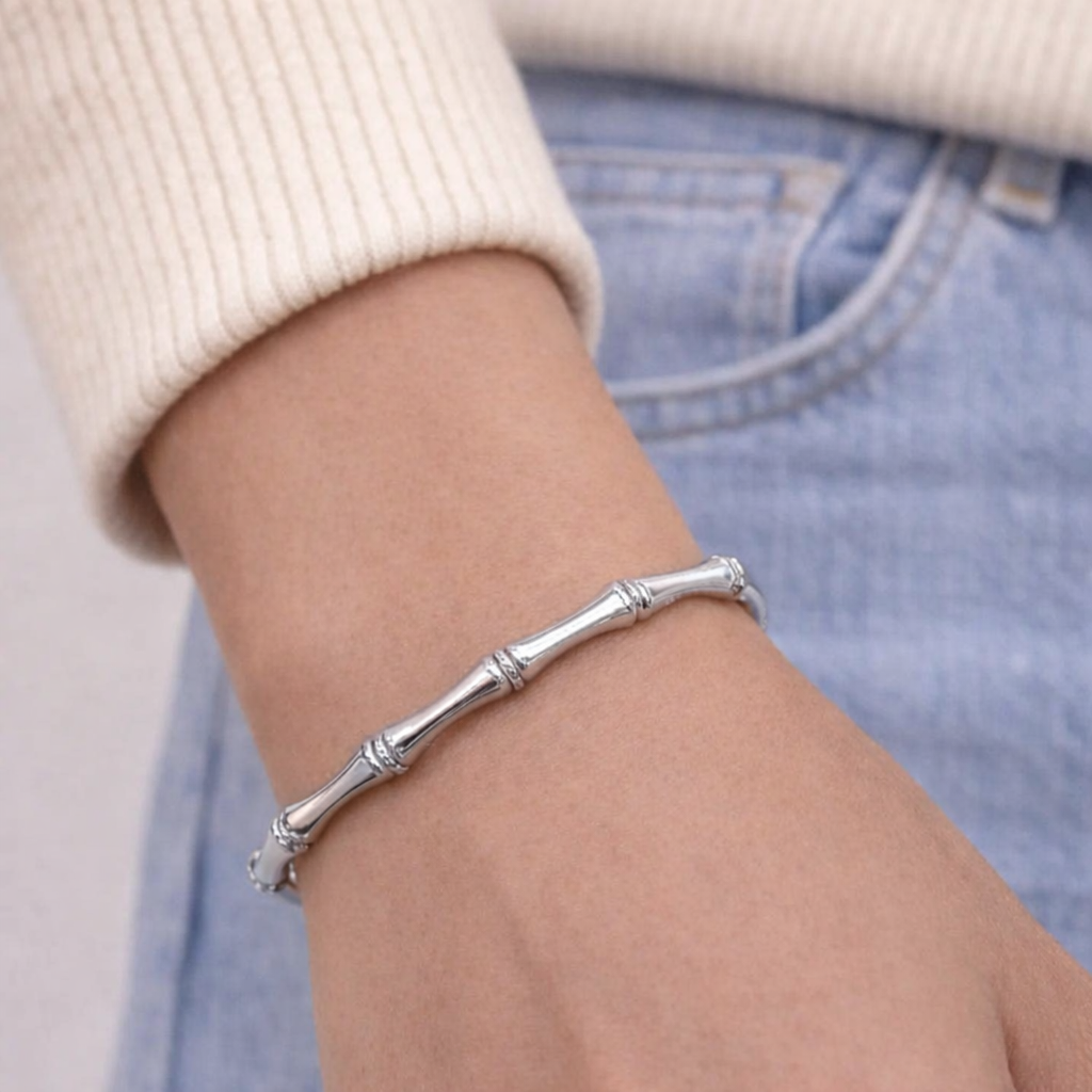 Silver bracelet on a wrist with a blurred background