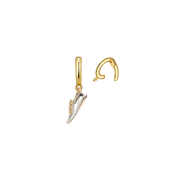 Gold shoe-shaped earrings on a white background
