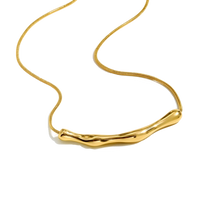 Gold necklace with a unique design on a white background
