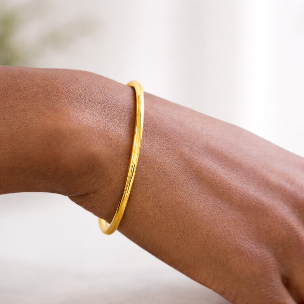 Gold bracelet on a wrist with a blurred background