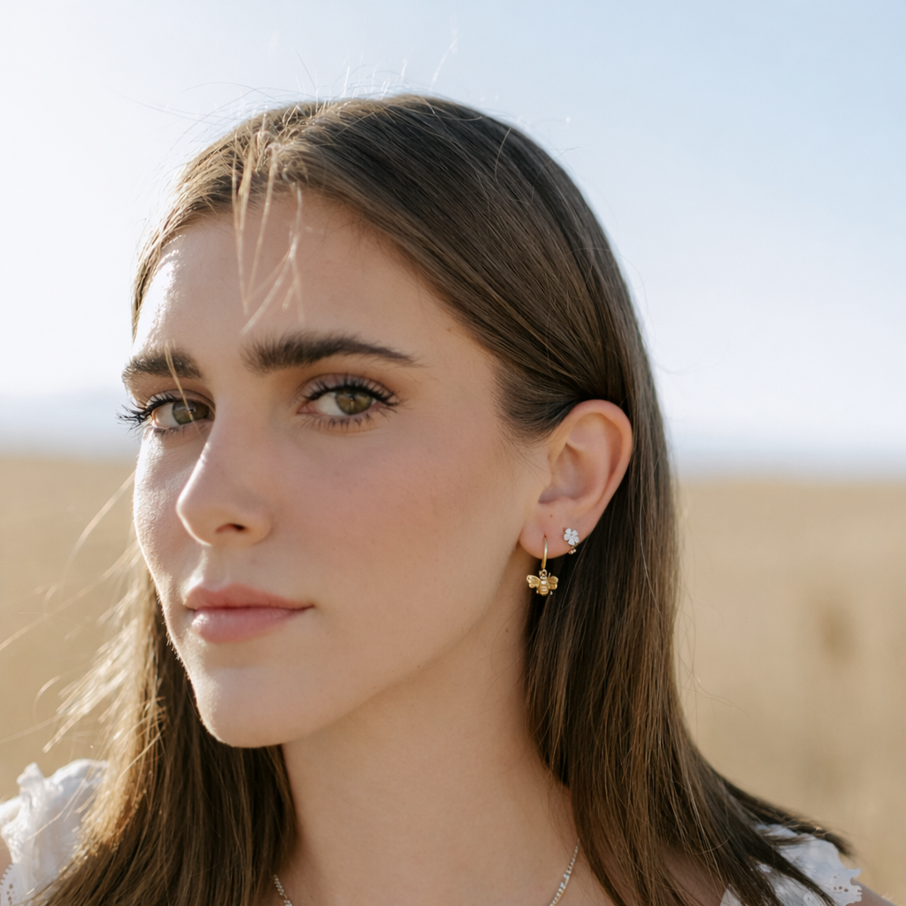 Close-up of a woman wearing earrings with a blurred desert background