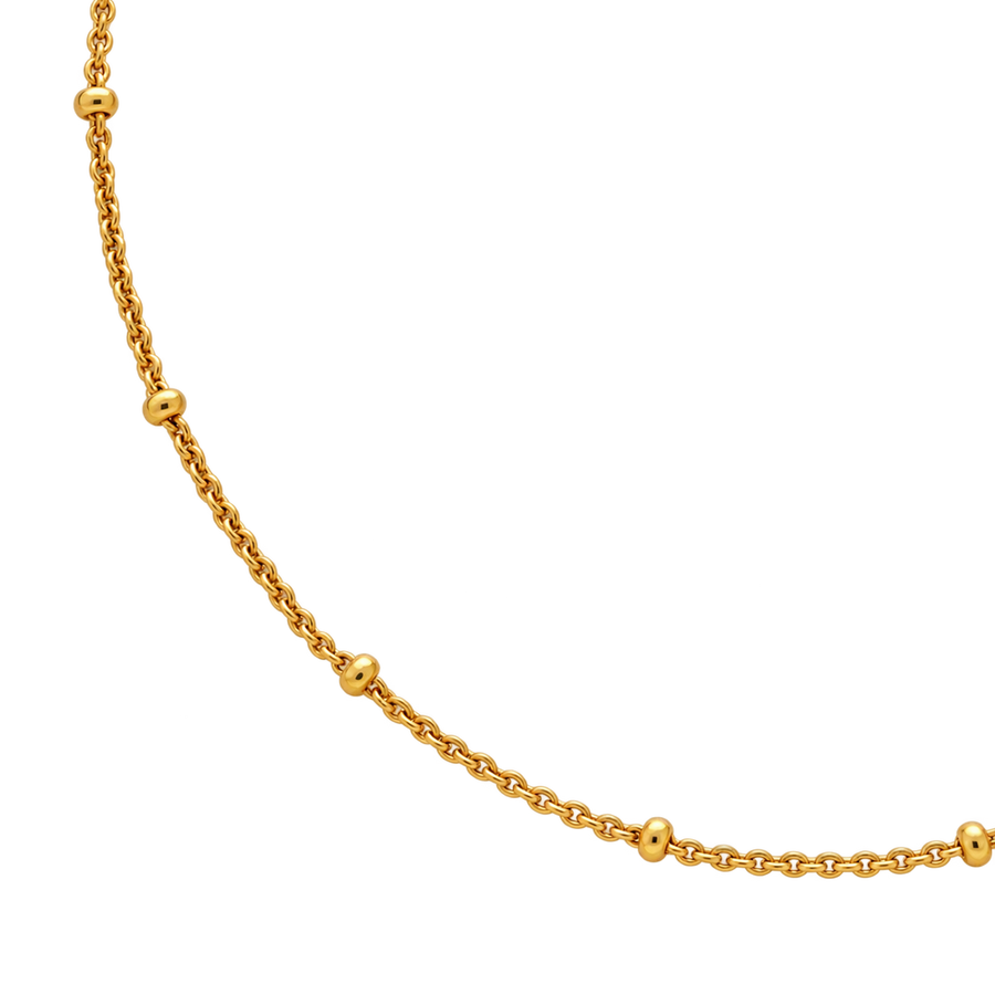 A gold chain necklace featuring evenly spaced, polished round bead links, shown against a solid white background.
