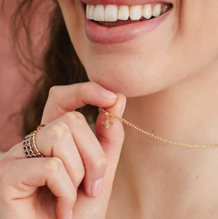 Bee Gemstone Charm necklace being worn on a website page
