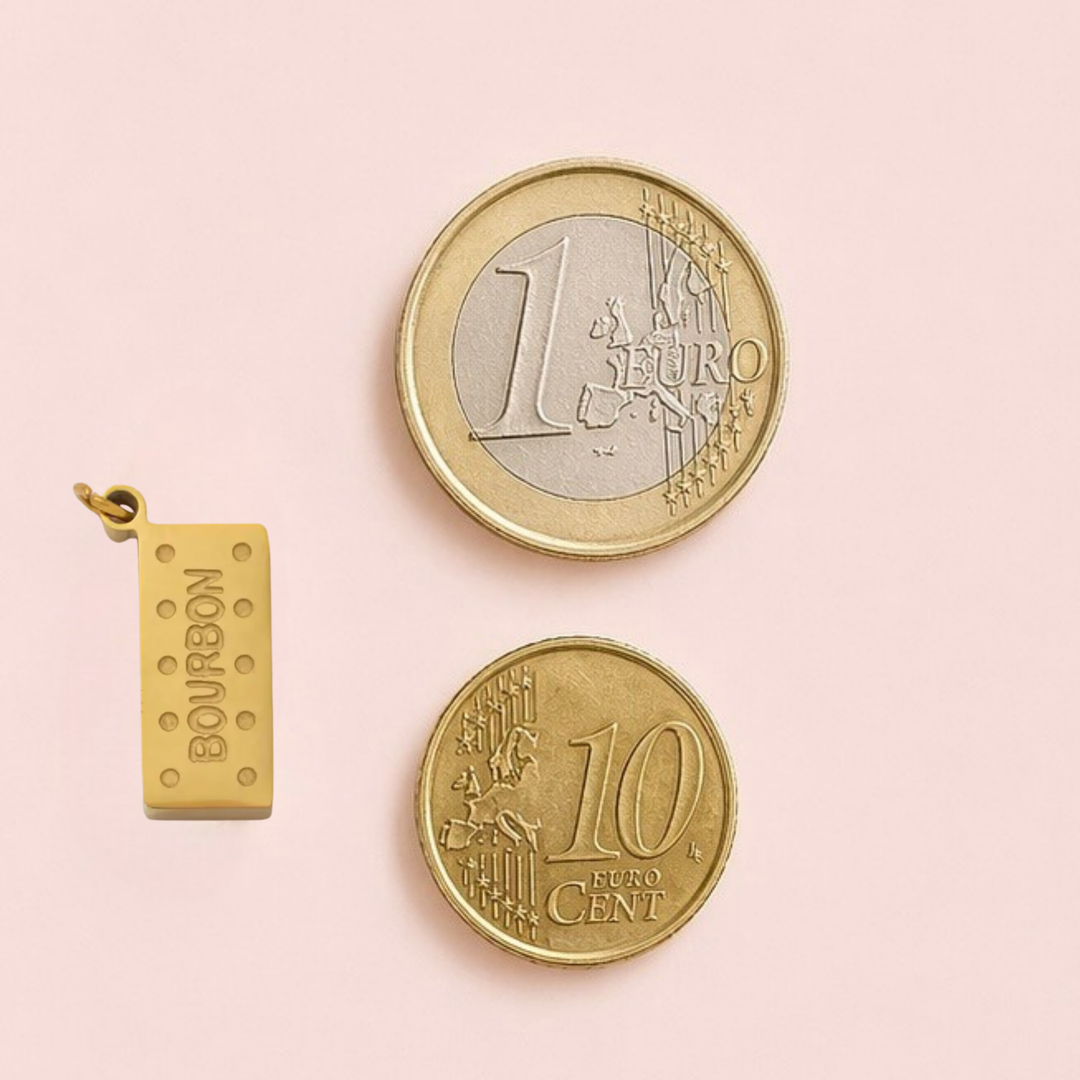 Two gold coins and a gold pendant on a pink background