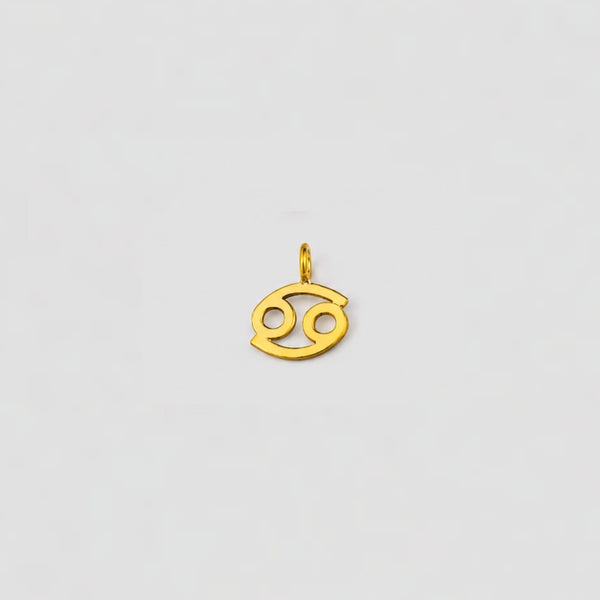Gold Cancer zodiac pendant on a light gray background