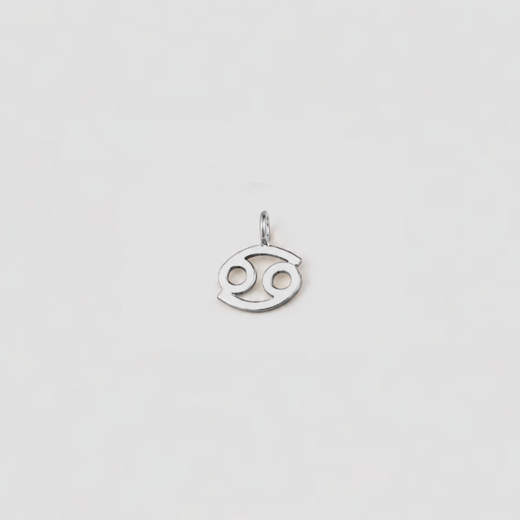 Silver Cancer zodiac sign pendant on a light gray background