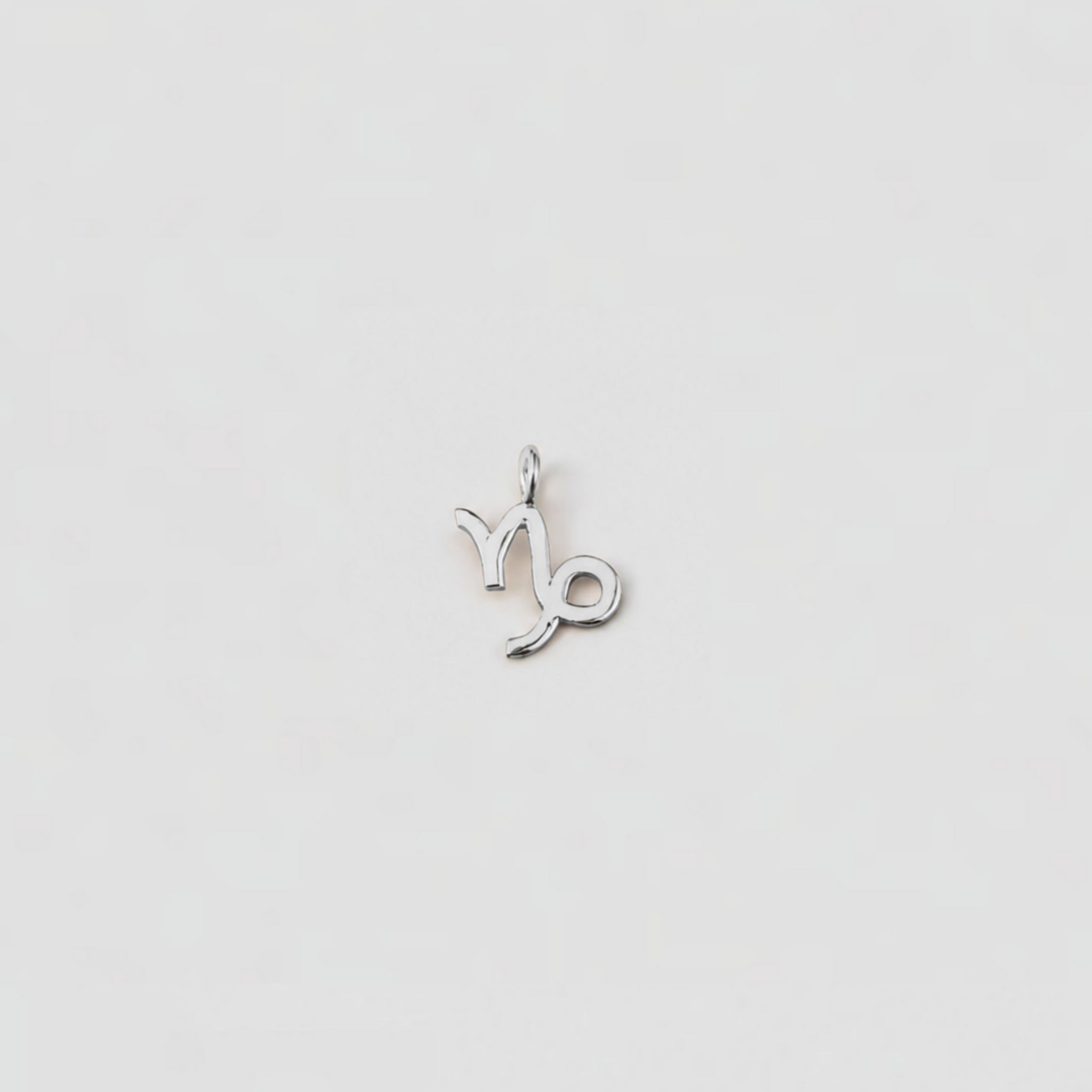 Silver Aries zodiac sign pendant on a light gray background
