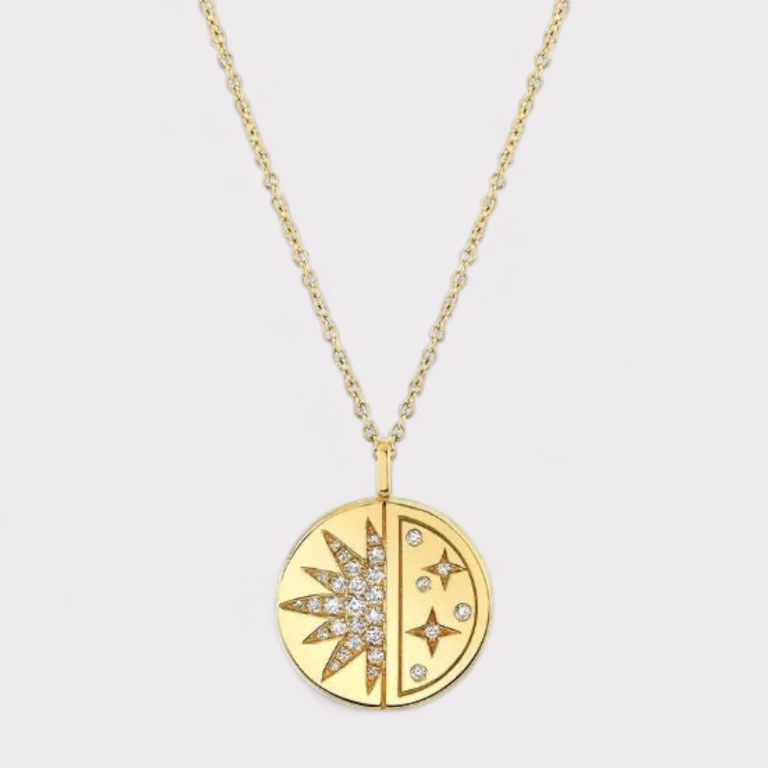 Gold necklace with a circular pendant featuring star designs on a light gray background
