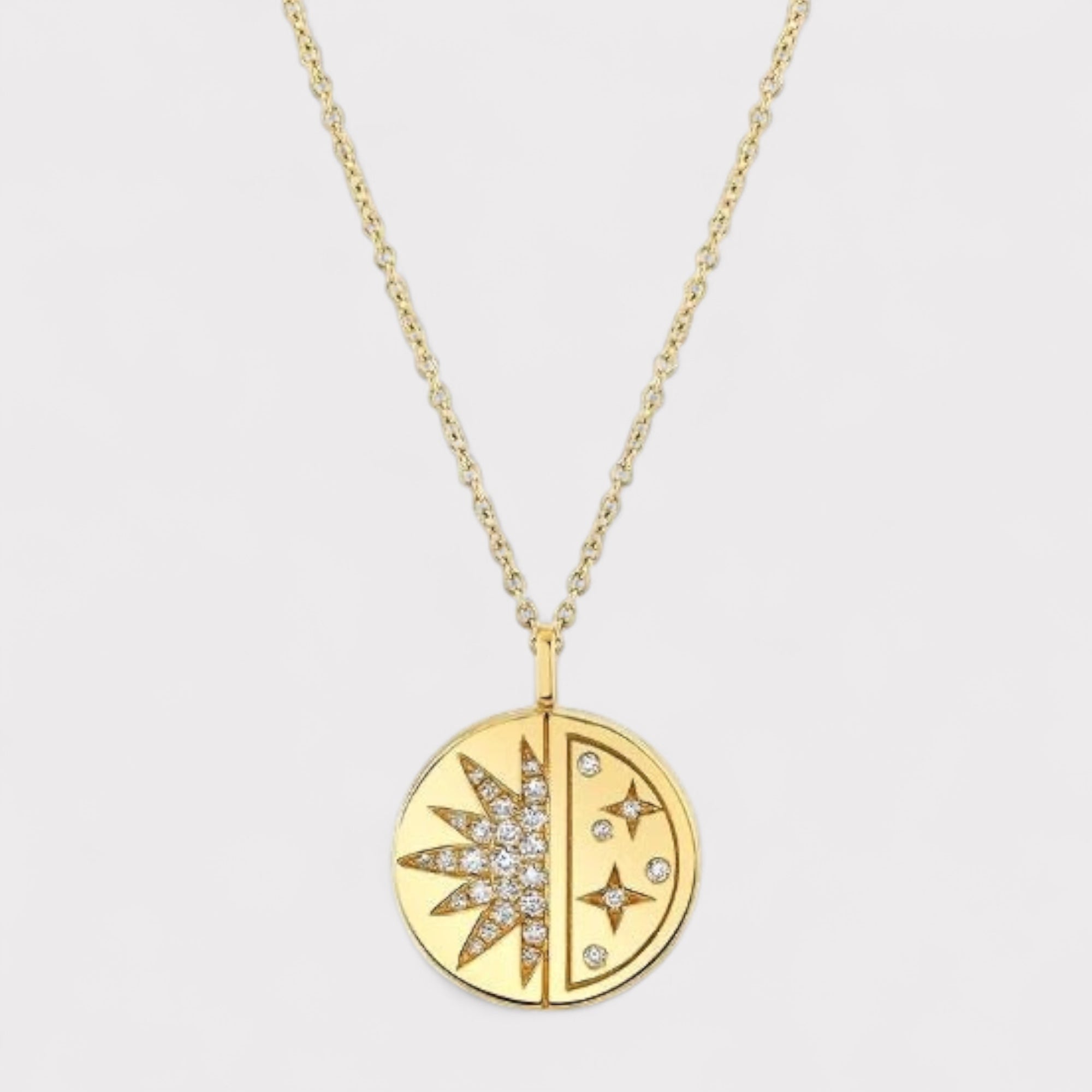 Gold necklace with a circular pendant featuring star designs on a light gray background