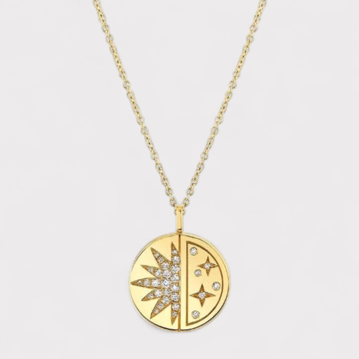 Gold necklace with a circular pendant featuring star designs on a light gray background