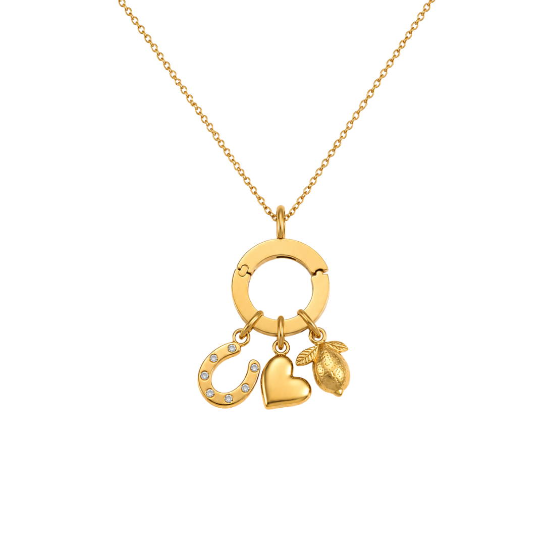 Gold necklace with three charms on a white background