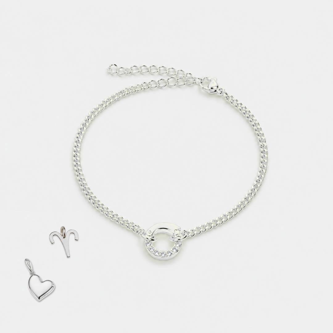 Silver bracelet and heart-shaped pendant on a white background