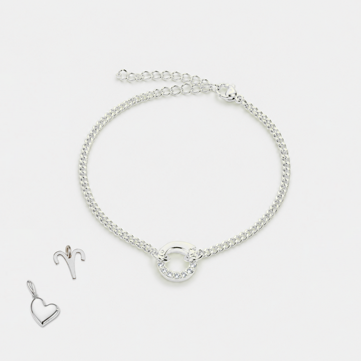 Silver bracelet and heart-shaped pendant on a white background