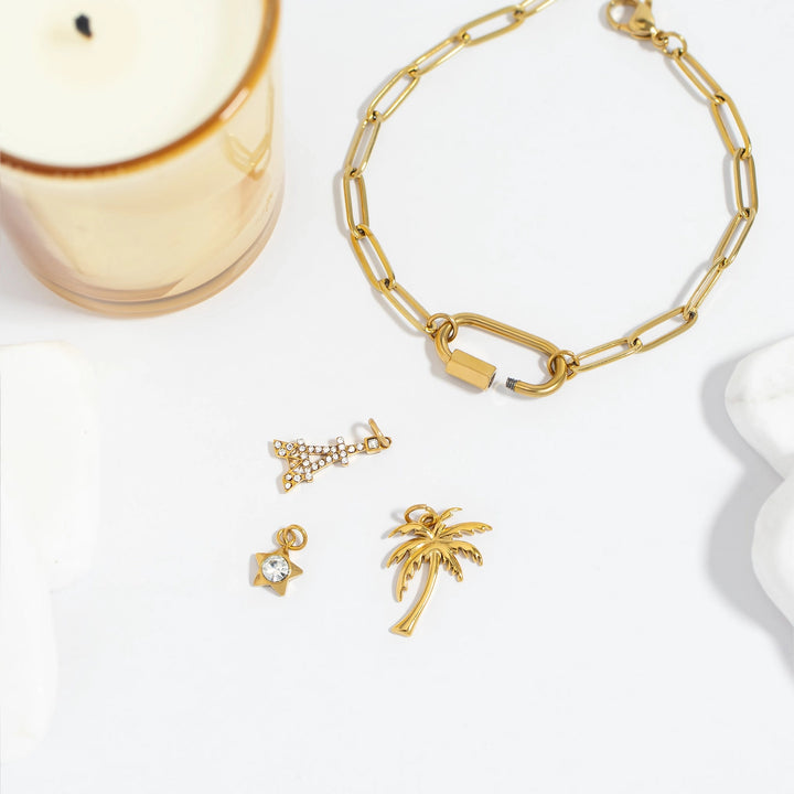 Gold jewelry including a bracelet, necklace, and earrings on a white background