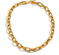 A chunky gold paperclip chain necklace arranged in a circle on a white background with soft drop shadows.
