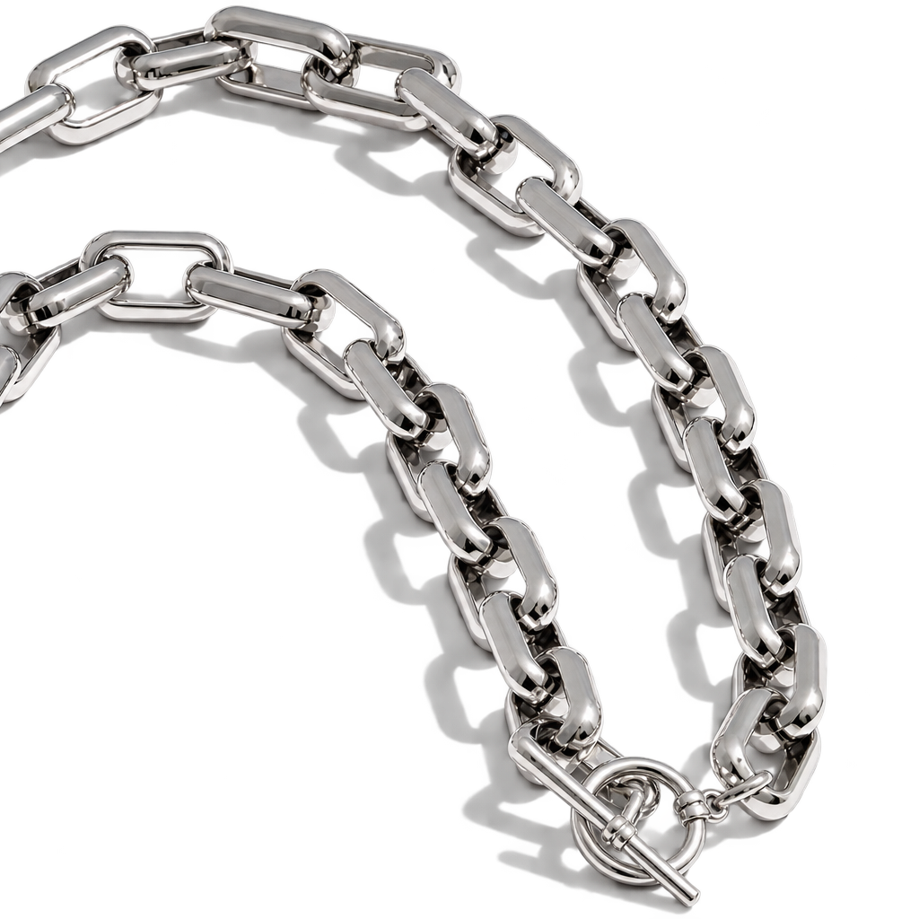A polished silver-tone metal link chain necklace with a toggle clasp, arranged in a curved loop on a clean white background.