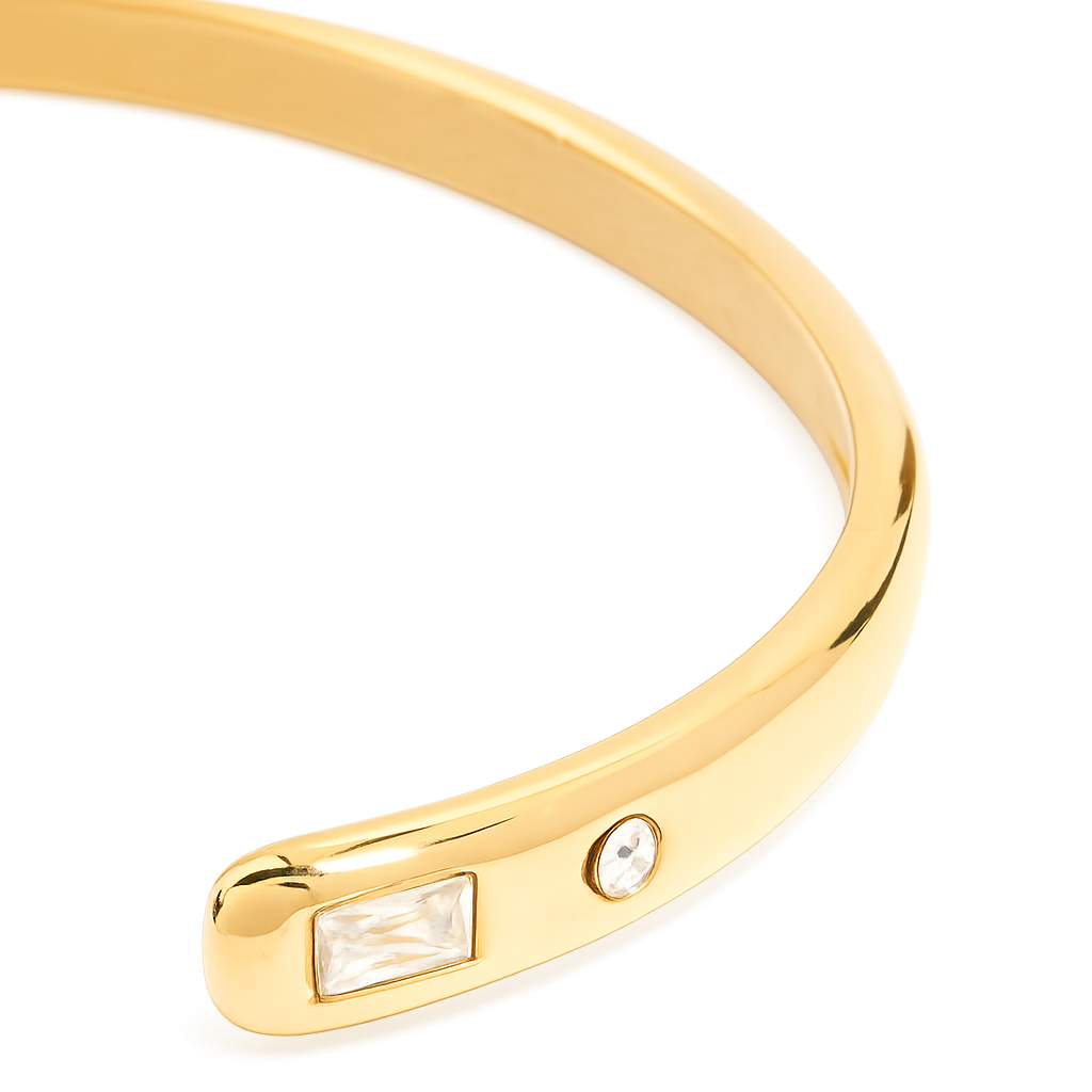 Gold bracelet with embedded gemstones on a white background