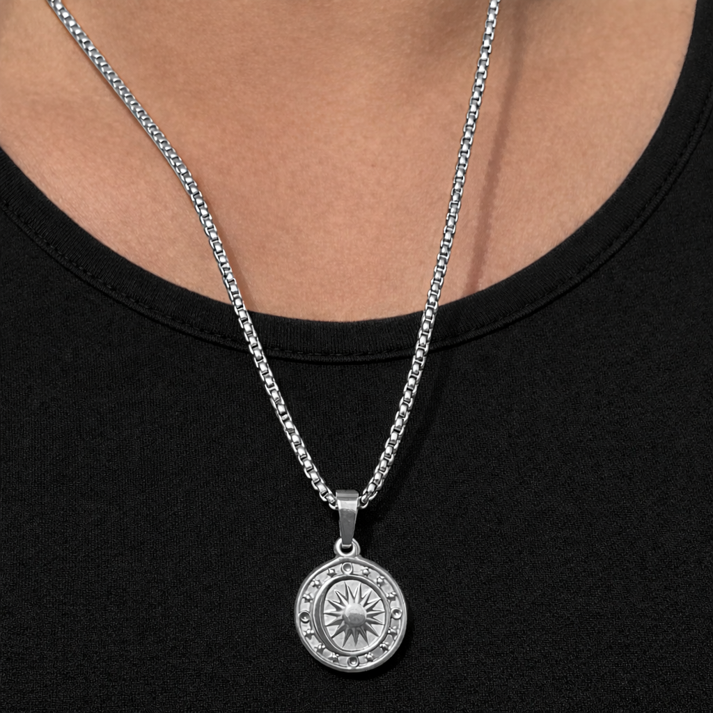 Silver necklace with a pendant on a black background