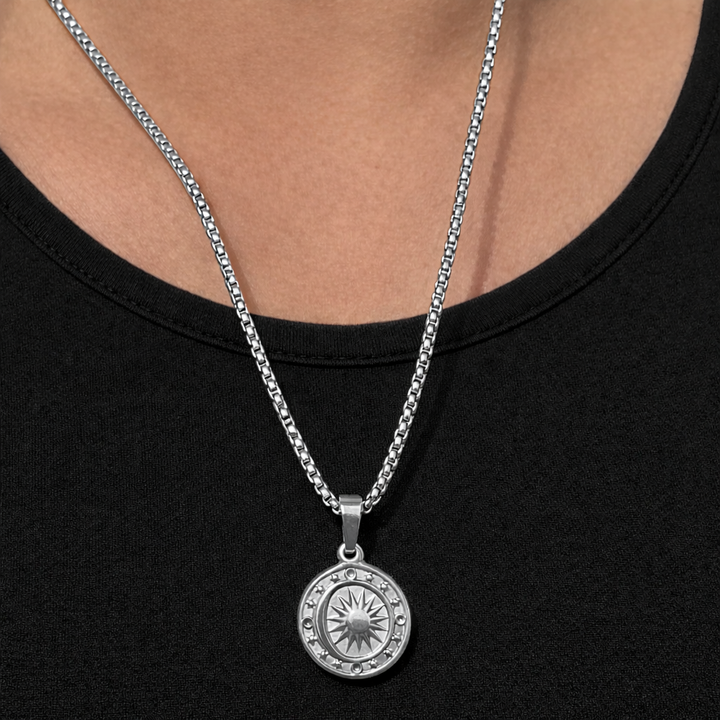 Silver necklace with a pendant on a black background