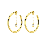 Gold hoop earrings with chain and gemstone drops on a white background