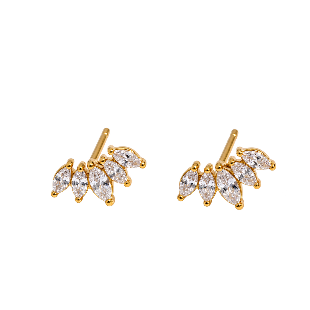 A pair of gold leaf-shaped stud earrings set with marquise-cut clear gemstones, shown on a plain white background.