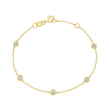 Gold bracelet with diamond accents on a white background