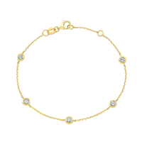 Gold bracelet with diamond accents on a white background