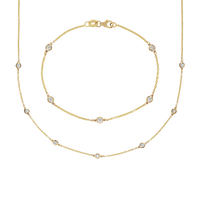 Gold necklace with small diamonds on a white background