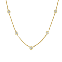 Gold necklace with small diamonds on a white background