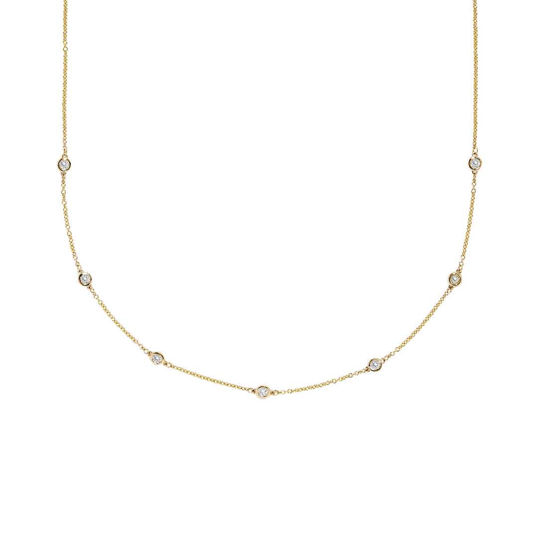 Gold necklace with small diamonds on a white background