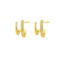 Gold hoop earrings with small diamonds on a white background