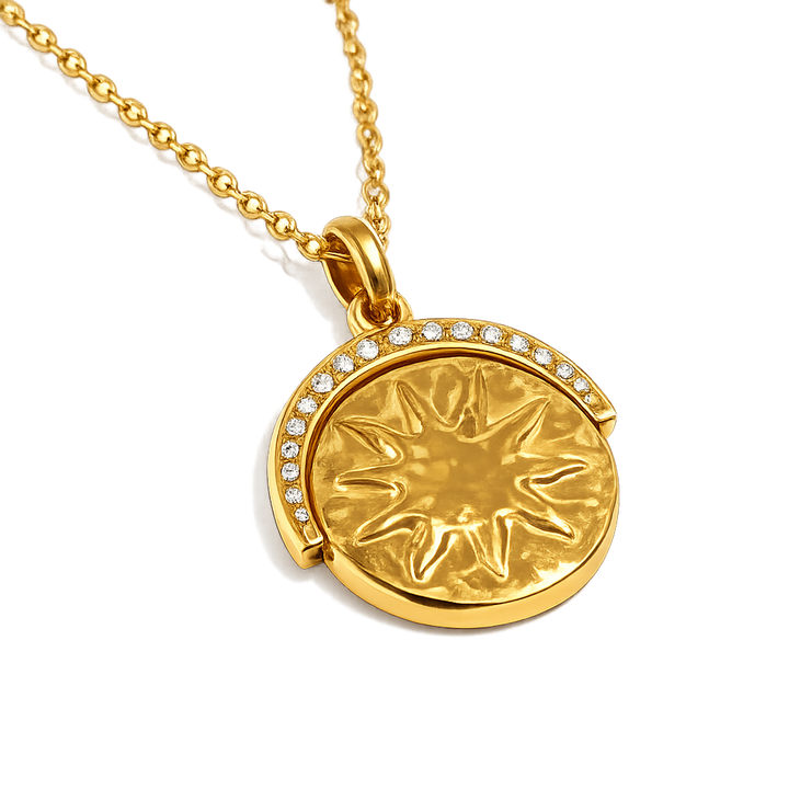 Gold necklace with a sun design pendant on a white background