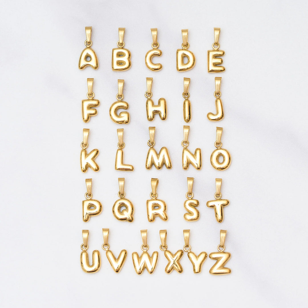 Gold letter pendants from A to Z on a white background
