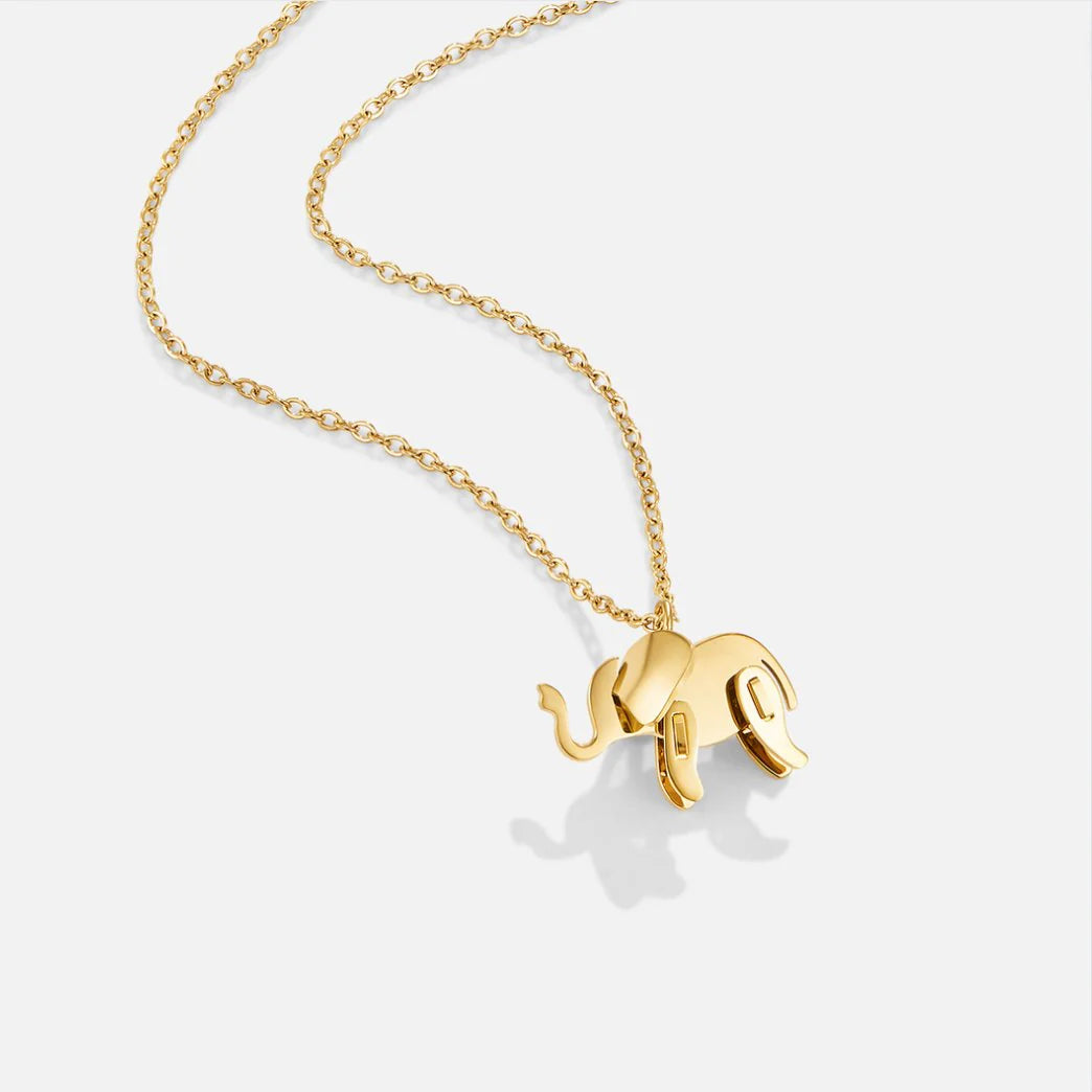 Gold elephant pendant necklace on a white background