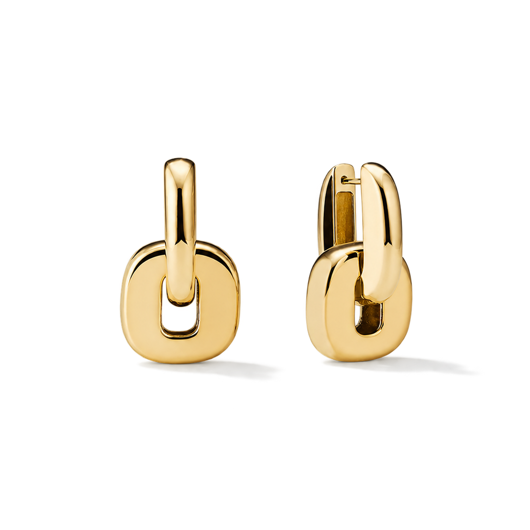 A pair of gold huggie hoop earrings with a thick, rounded open-link design, shown on a clean white background.