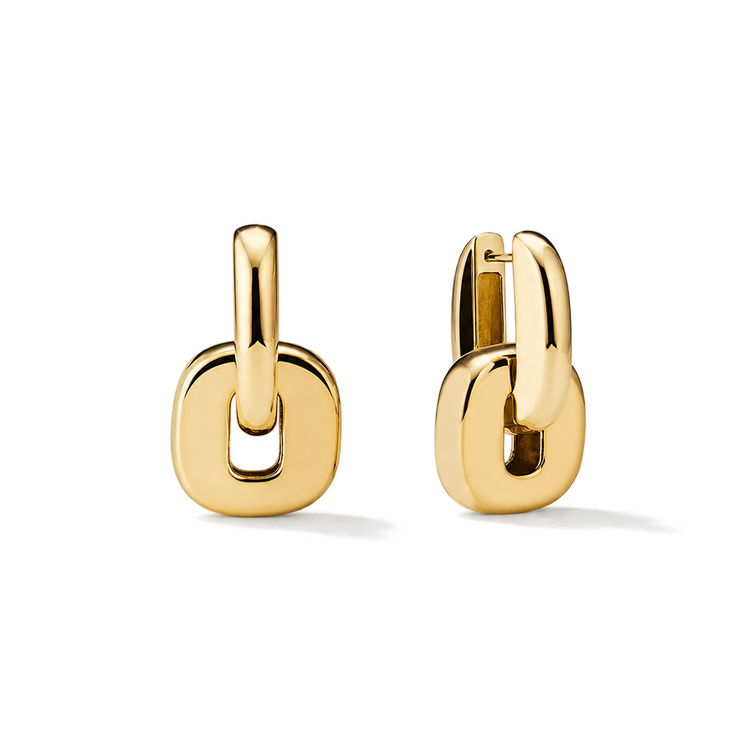 A pair of gold huggie hoop earrings with a thick, rounded open-link design, shown on a clean white background.