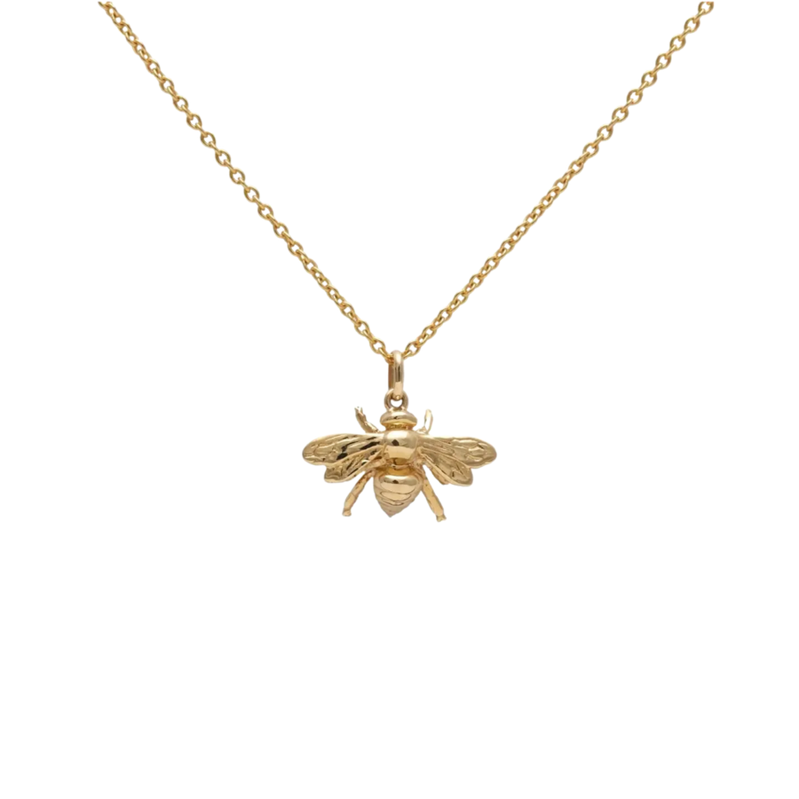 Gold bee pendant necklace on a white background
