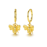 Gold bee-shaped earrings on a white background
