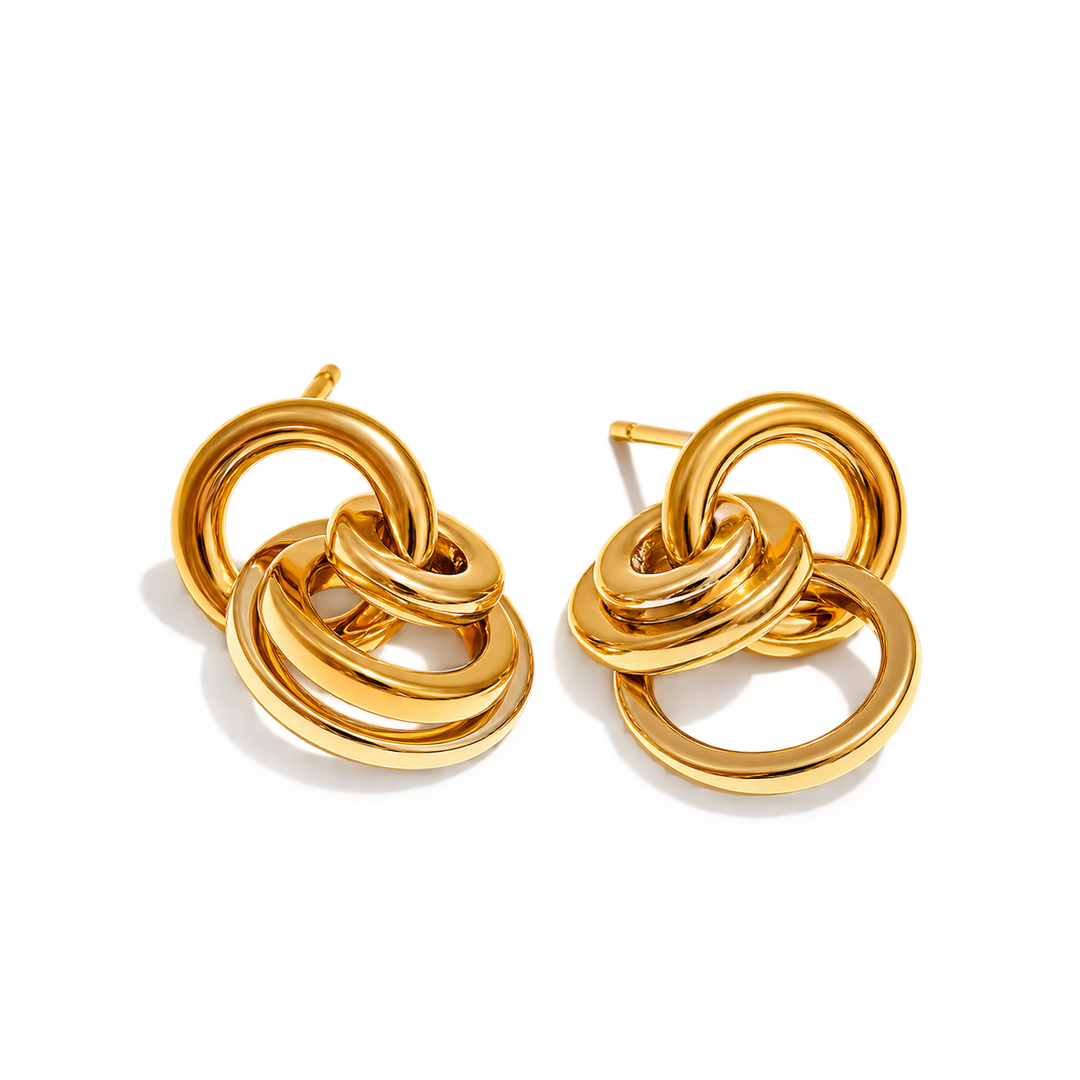 A pair of gold-toned interlocking ring stud earrings on a clean white background.