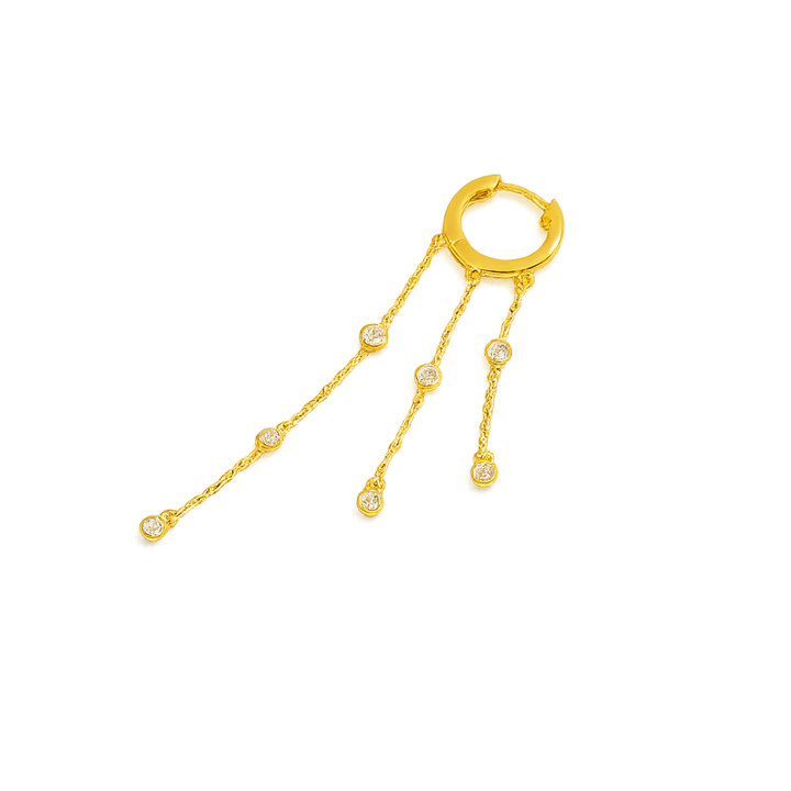 Gold hoop earring with dangling chain and beads on a white background