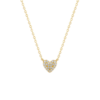 Gold necklace with a heart-shaped diamond pendant on a white background