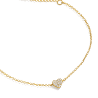 Gold necklace with a heart-shaped pendant on a white background