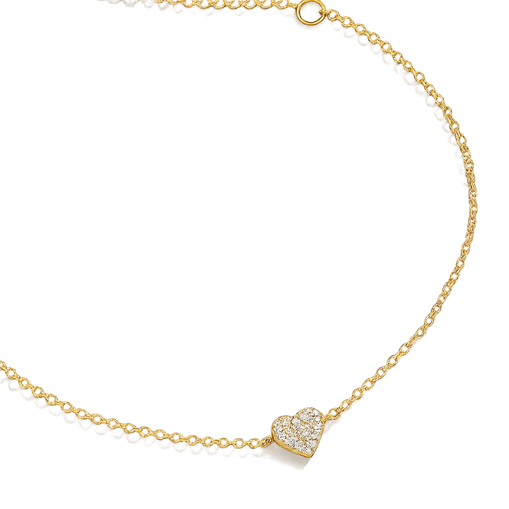 Gold necklace with a heart-shaped pendant on a white background