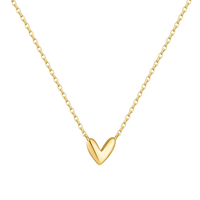 A delicate gold chain necklace featuring a polished, smooth gold heart pendant, shown against a solid white background.