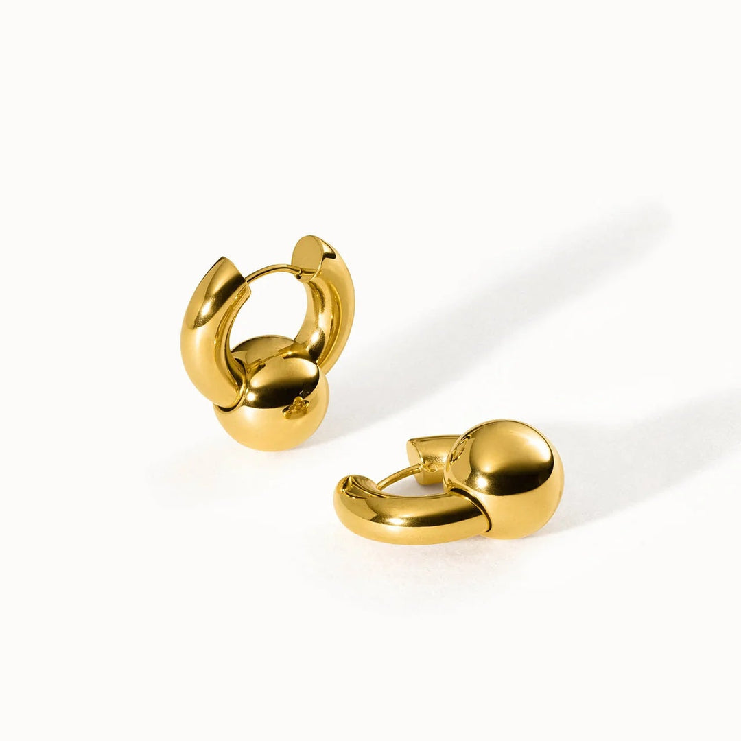 Gold hoop earrings on a white background