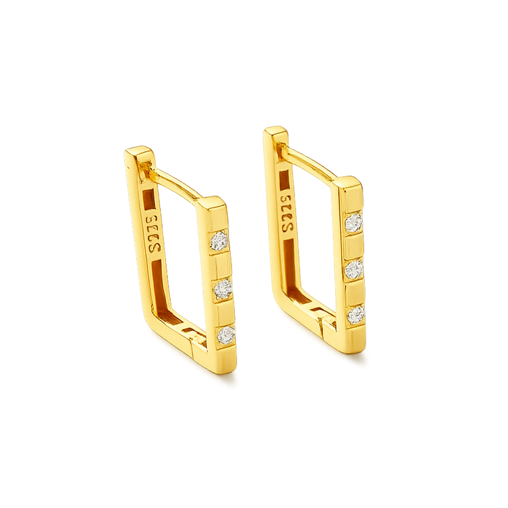 Gold earrings with diamond accents on a black background