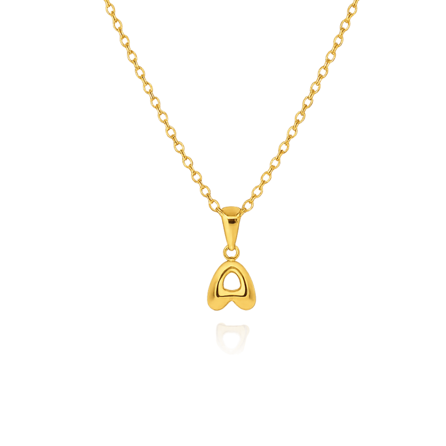 Gold necklace with a letter shaped pendant on a white background